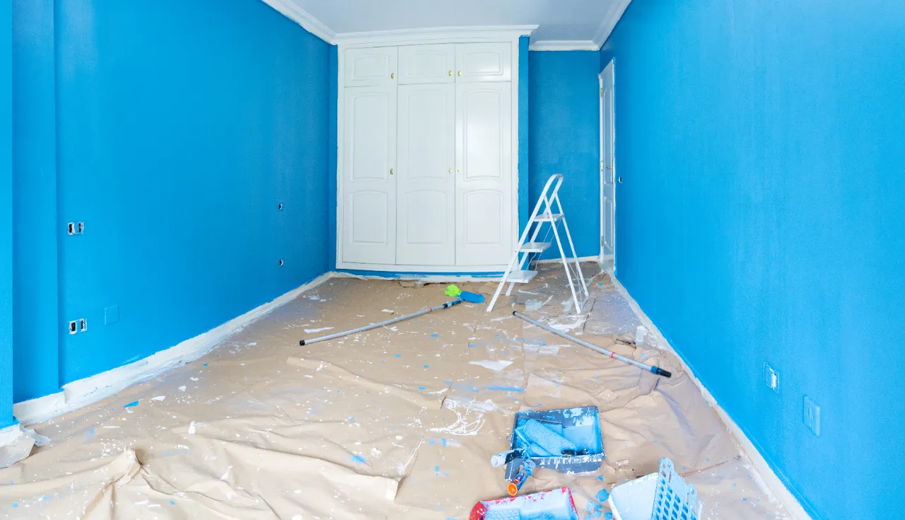 Blue room renovation with painting supplies and ladder in New Jersey