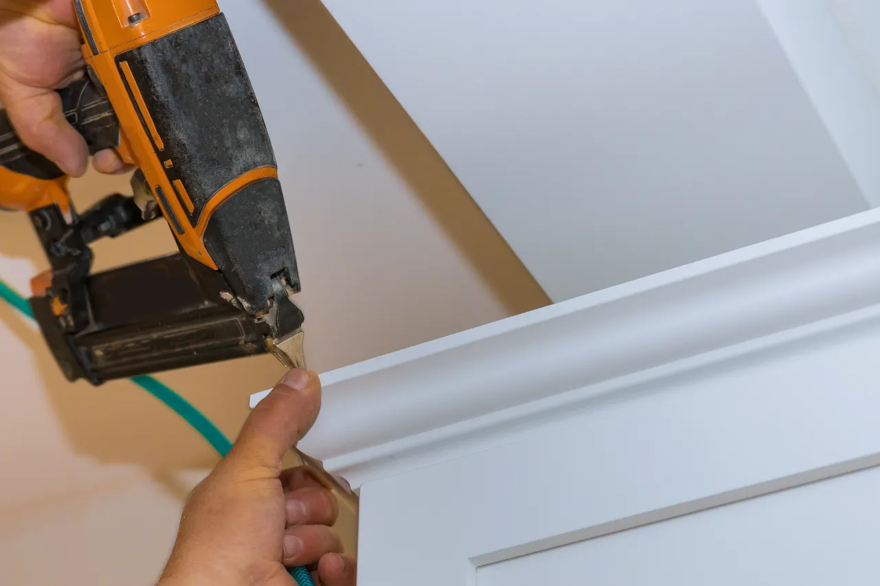 Installing crown molding trim with a nail gun in New Jersey