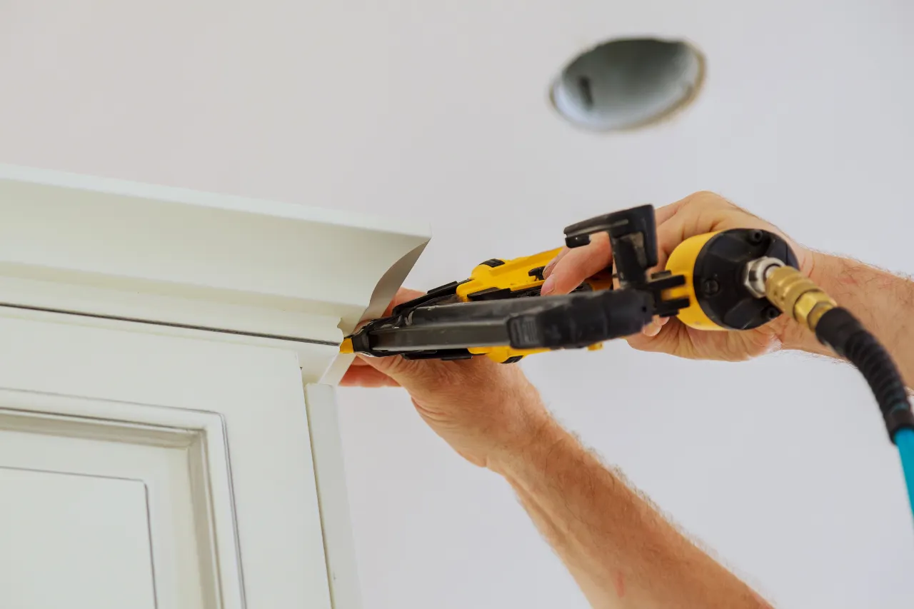 Installing decorative molding with a nail gun in New Jersey