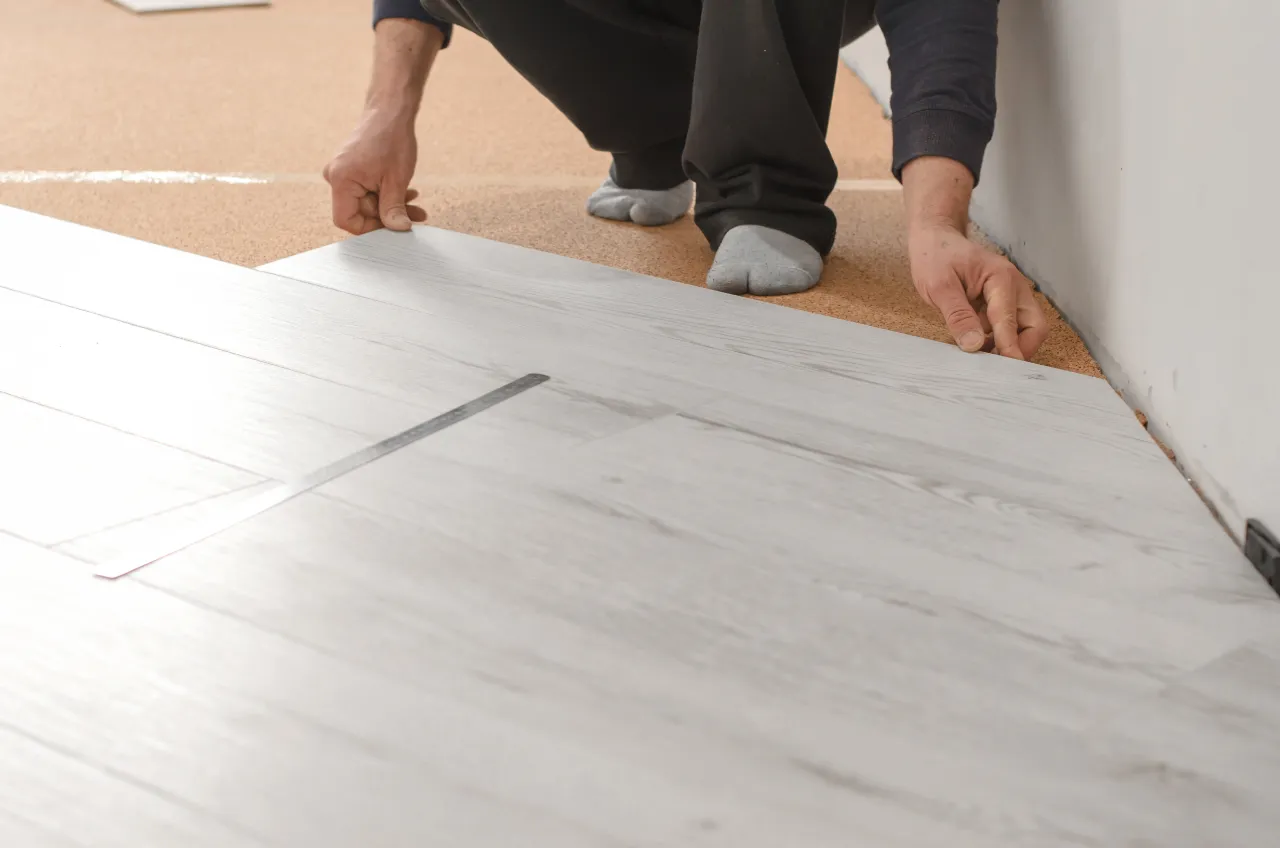 Installing new gray vinyl flooring at a New Jersey home