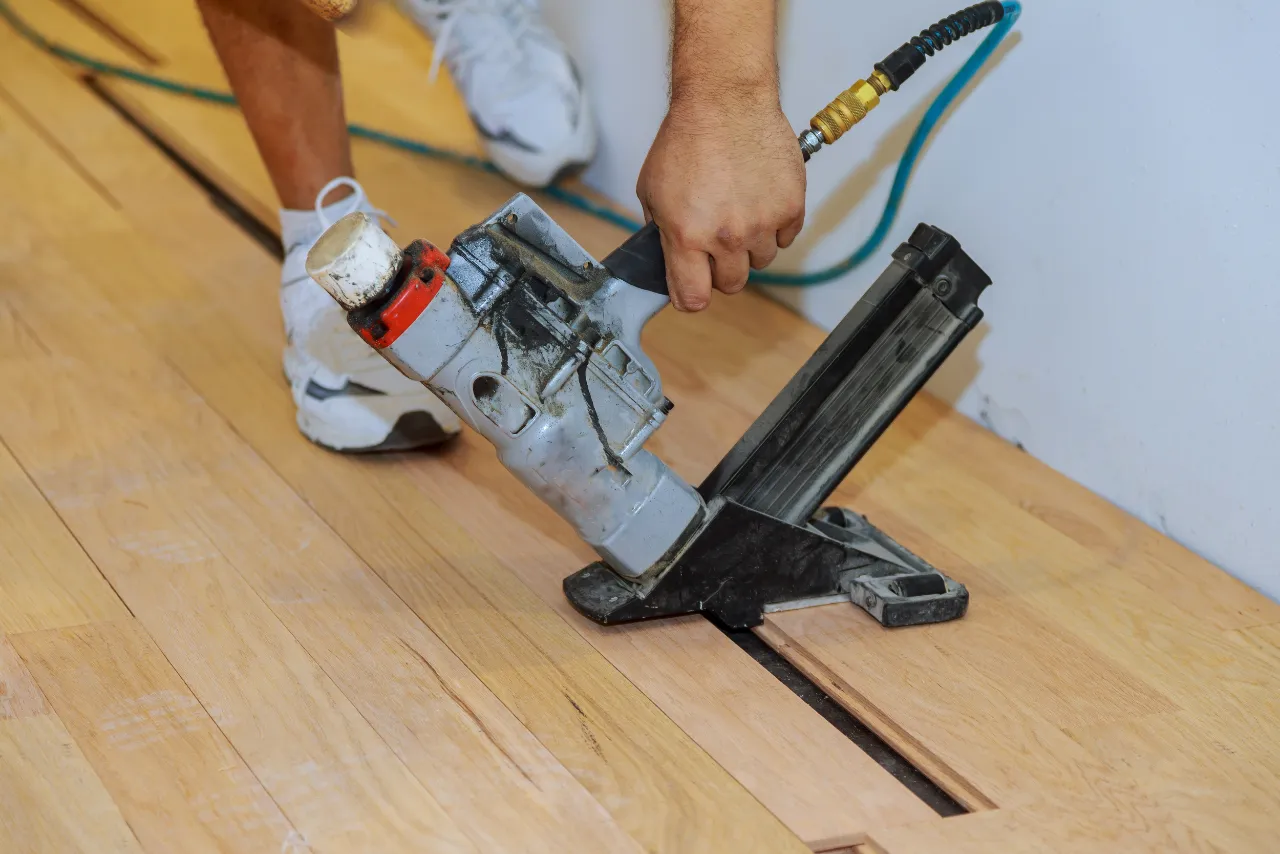 Installing new hardwood floor with a nail gun in New Jersey