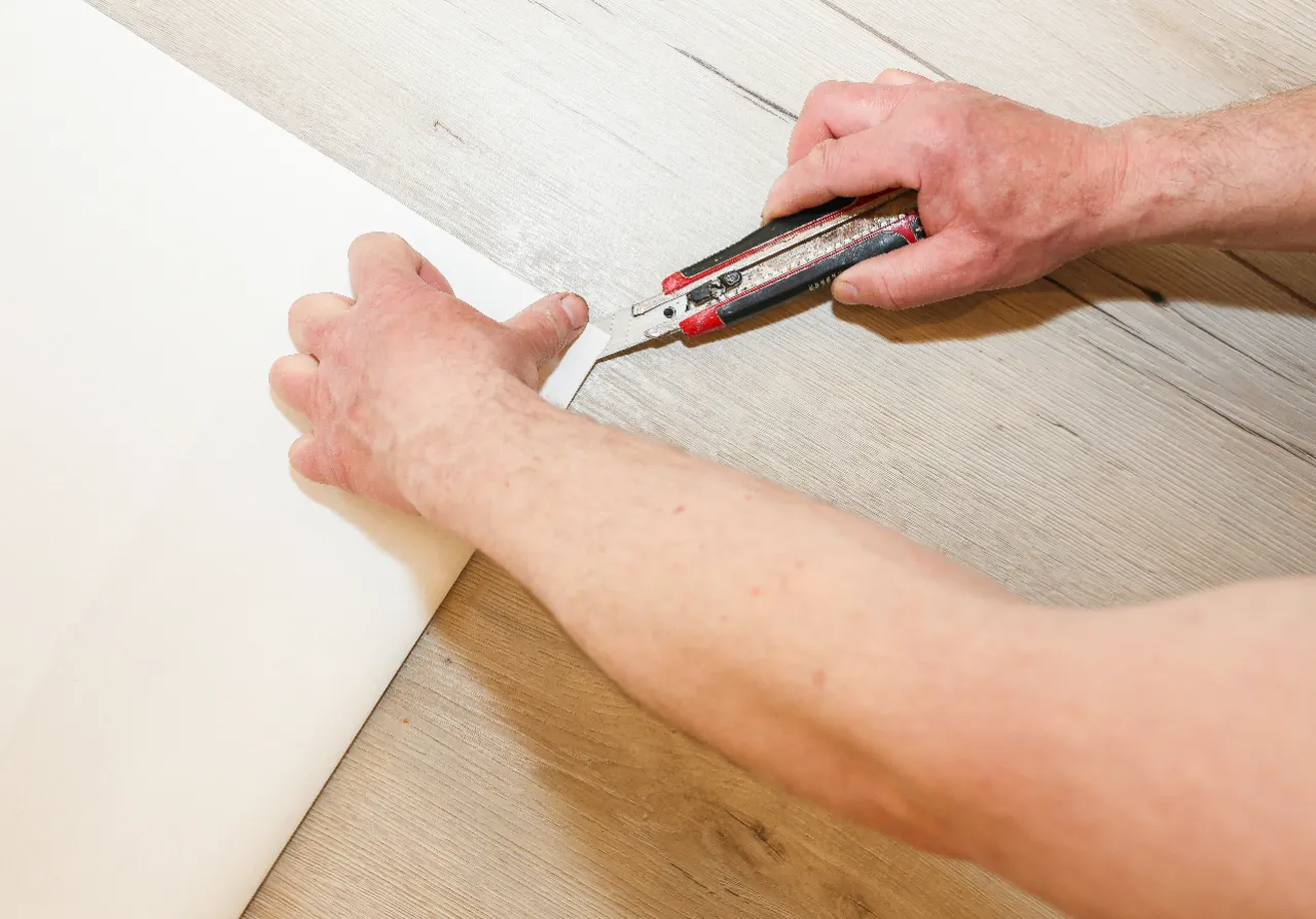 Vinyl flooring being cut and fitted in a New Jersey home