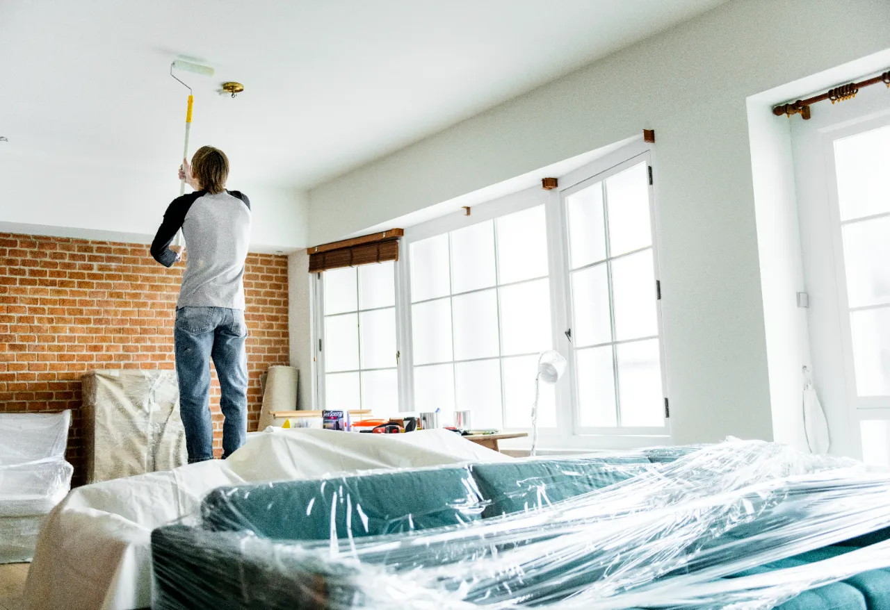 Man painting ceiling indoors in a New Jersey home