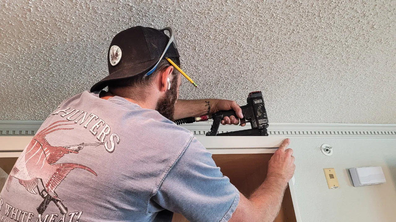 Man securing trim work with staple gun in New Jersey