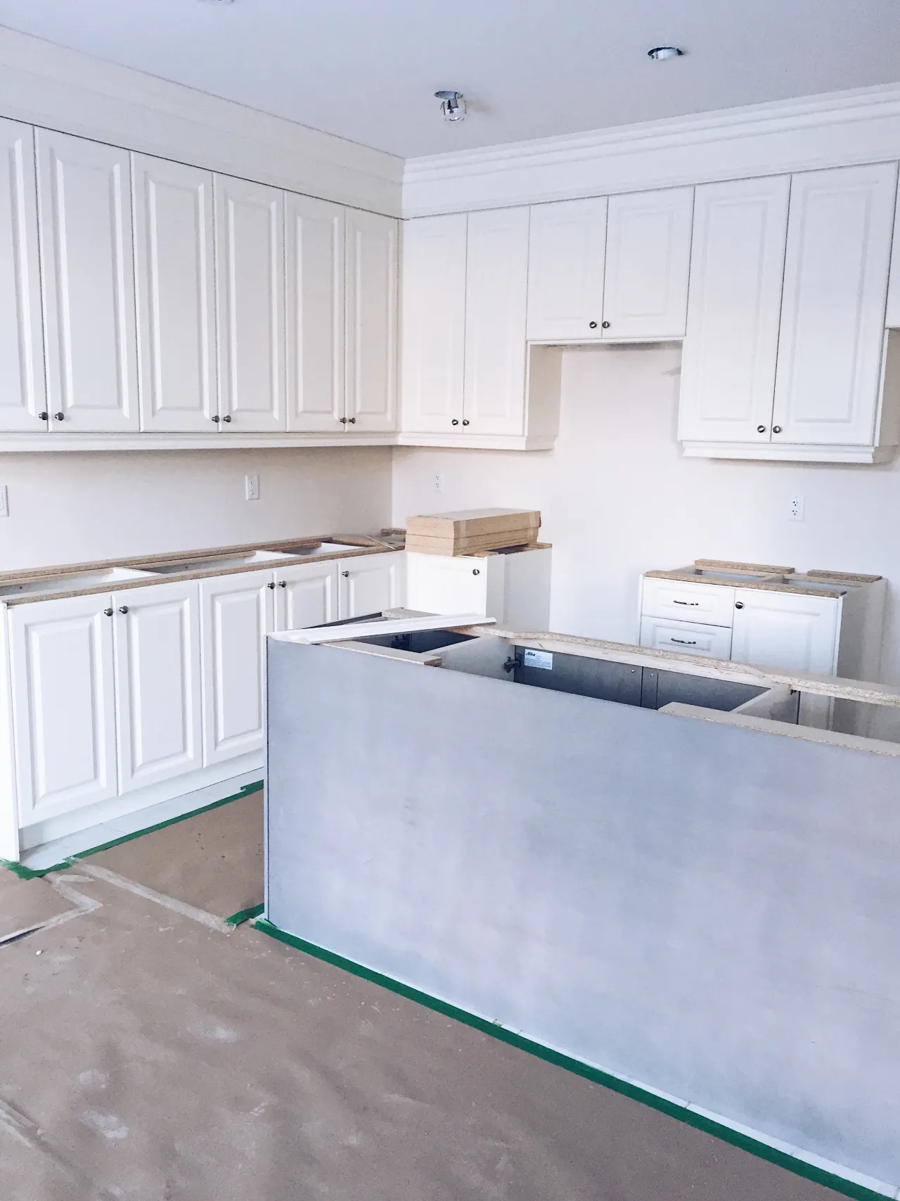 New kitchen under construction with white cabinets