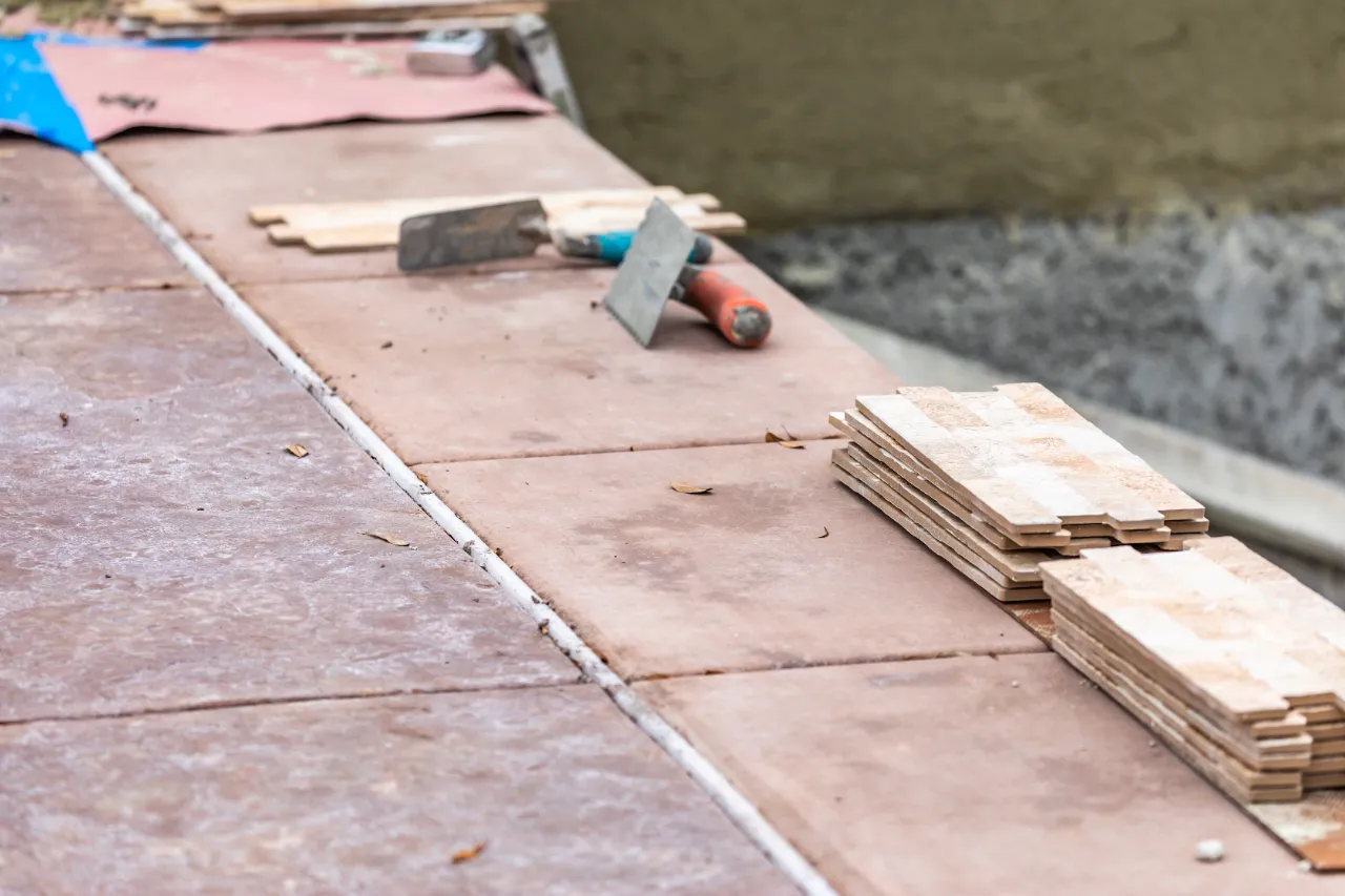 New tiles being laid on concrete in a New Jersey home