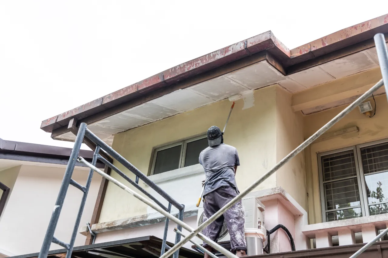 Painter adding undercoat to exterior wall in New Jersey