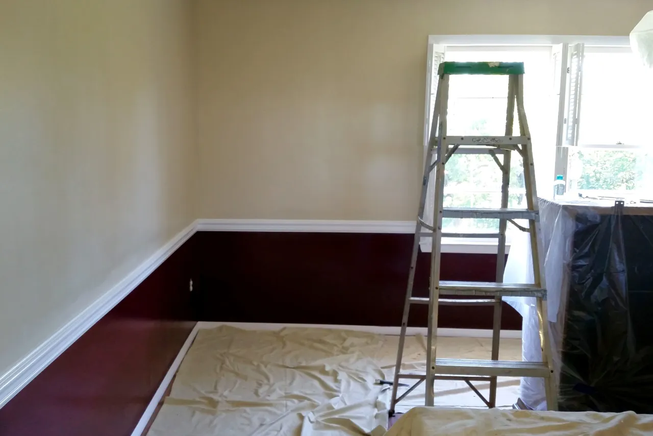 Room prepared for painting with ladder and coverings in New Jersey