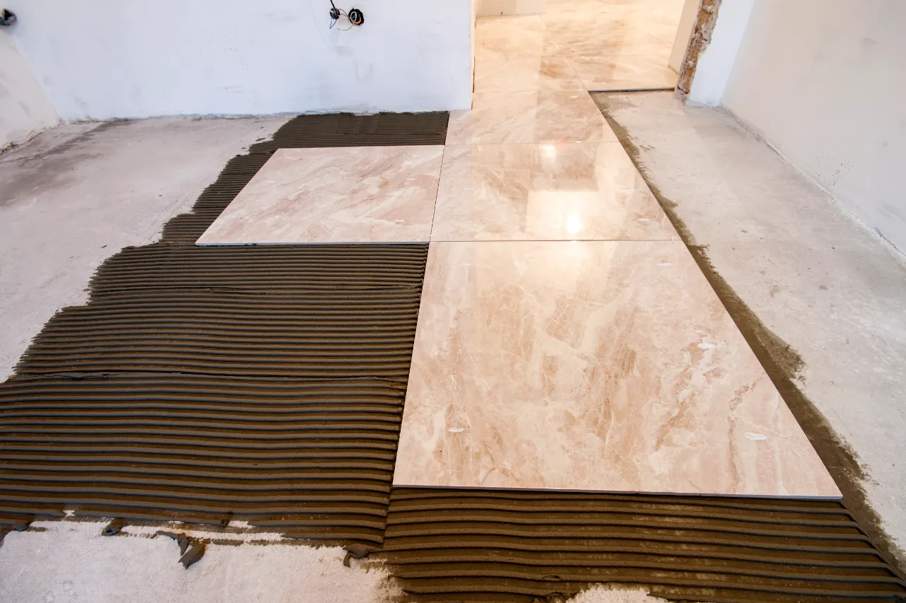 Tiling project with marble tiles and adhesive in New Jersey