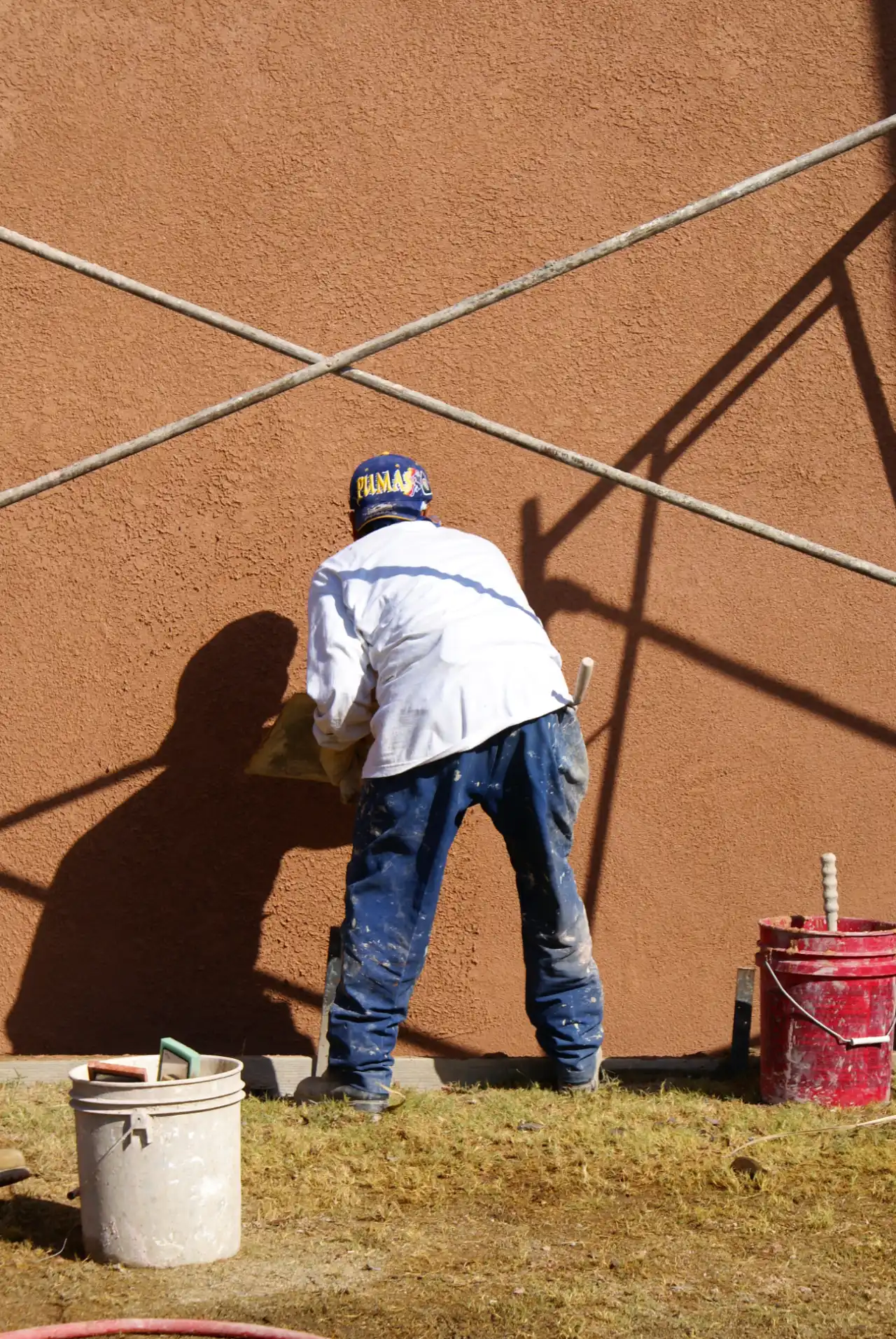 Worker applying finish to building exterior in New Jersey